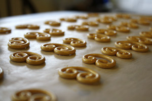 golden sugarpaste curls on a sheet of paper